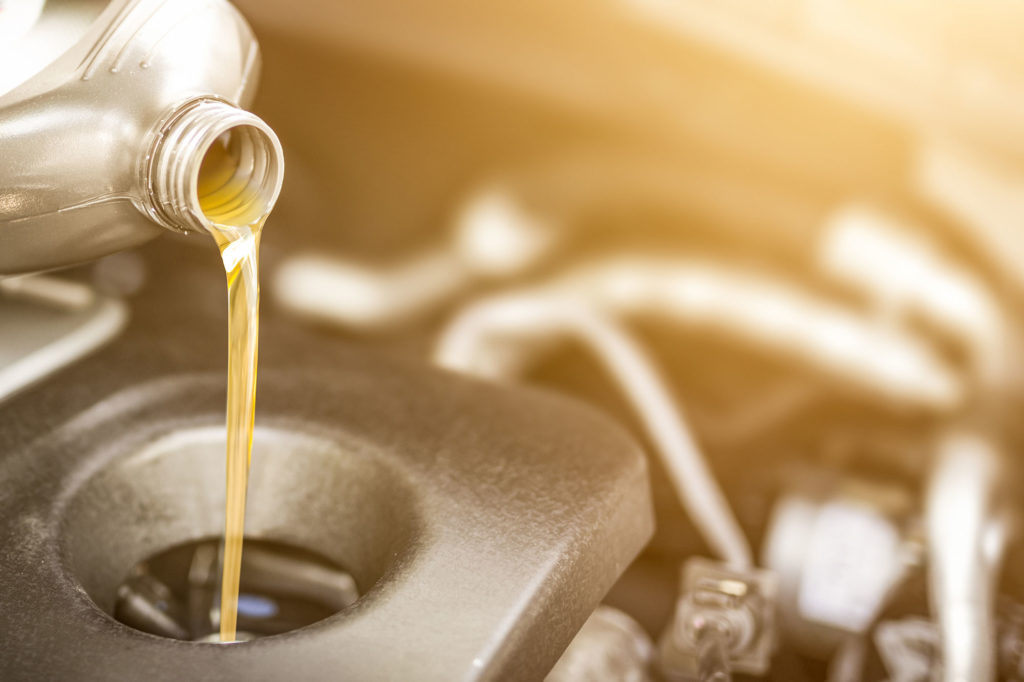 Pouring-oil-to-car-engine.-Fresh-oil-poured-during-an-oil-change-to-a-car
